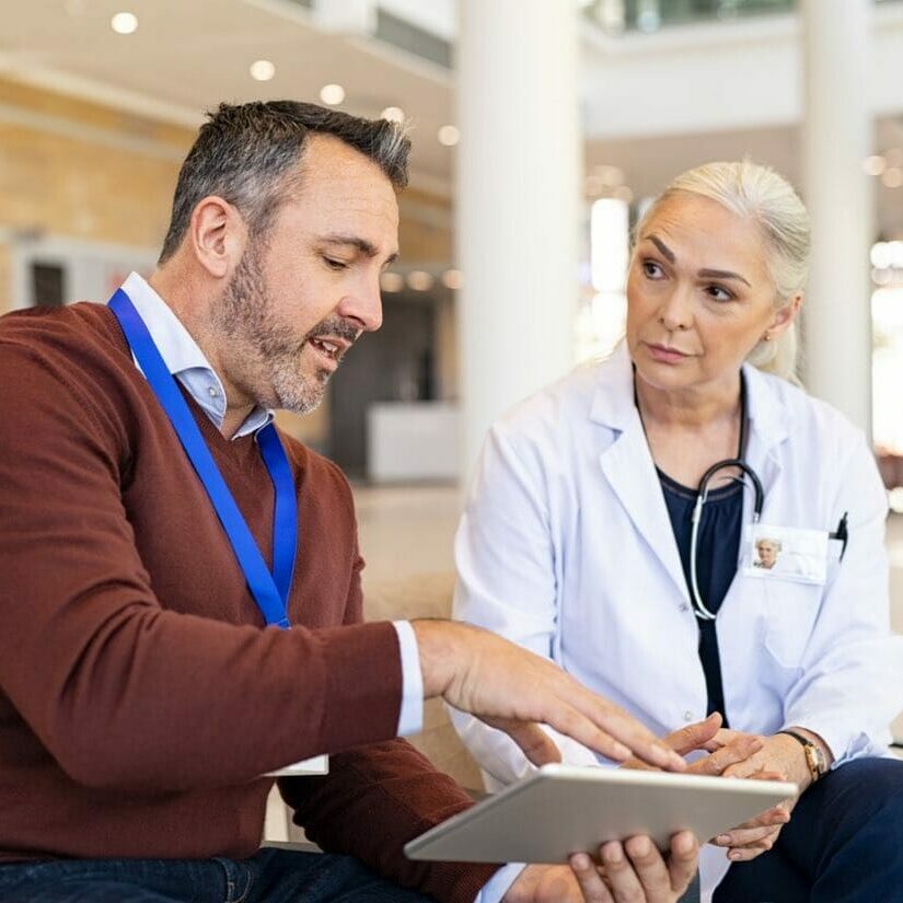 Pharmaceutical representative showing test results of new medicine to docto